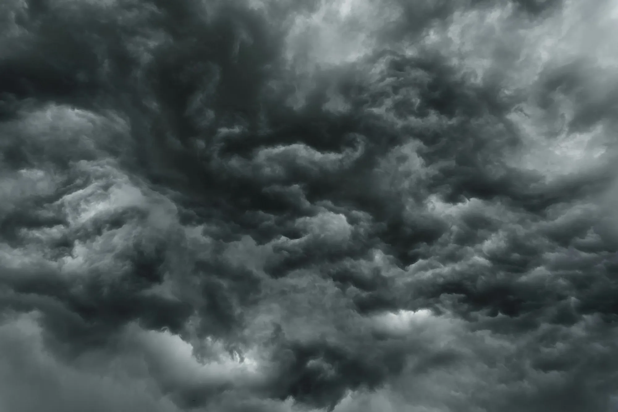 Churning gray storm clouds filling the sky over Doraville, the kind of storm that leaves roof damage behind